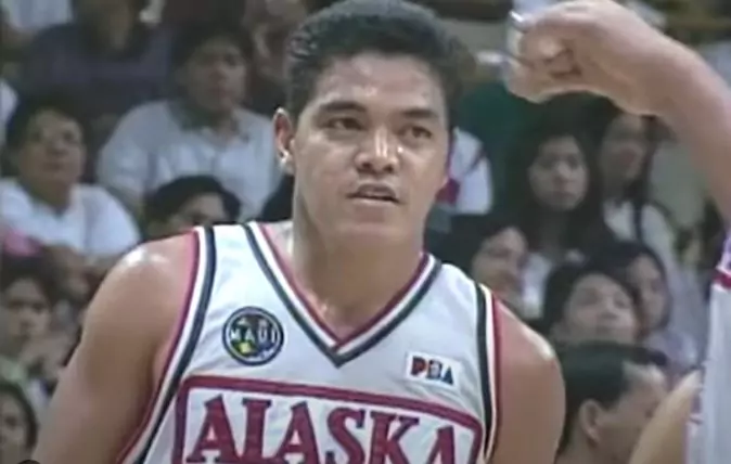 photo of man in middle of basketball game
